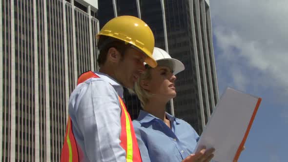 Male and female construction workers on a site