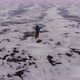 Aerial View of the Traveler Skating on the Ice of a Frozen Lake. - VideoHive Item for Sale