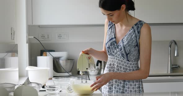 very thin young European woman cooking desserts