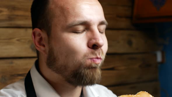 Bearded Young Man Eating Burger