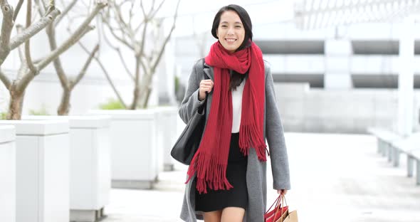 Woman look at mobile phone with shopping bag