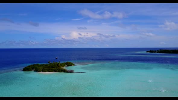 Aerial drone shot travel of tranquil coast beach trip by blue green sea with white sand background o