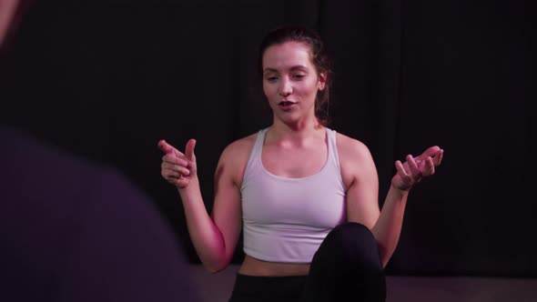 Pretty Yoga Coach Tells the Basic Rules of the Class
