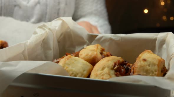 Female Hands Taking Christmas Cookies From a Baking Tray and Putting It in Box