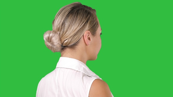 Woman placing hands on her hips on a Green Screen, Chroma Key.