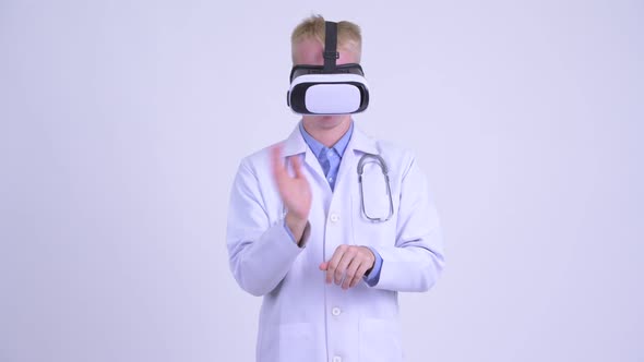 Young Blonde Man Doctor Using Virtual Reality Headset