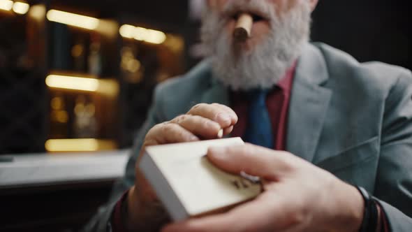 Close Up Shot of Unrecognizable Bearded Senior Man Burning Match and Lighting Cigar Free Space