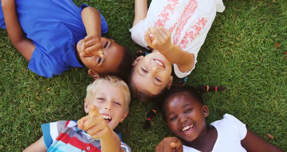Group of kids lying on grass and having fun alt