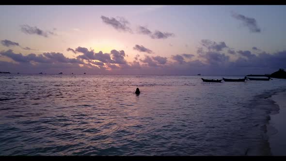 Tourists sunbathing on idyllic lagoon beach journey by blue water and white sand background of the M