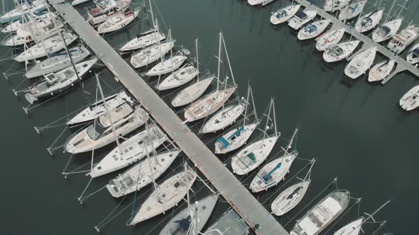 Aerial Drone Flying Out Over a Marina for Boats and Tourist Ships