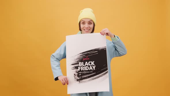 Black Friday Video Footage - A Woman Holding A Black Friday Sale Posters