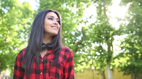 Portrait of a beautiful mixed race asian girl with headphones to listen to mu