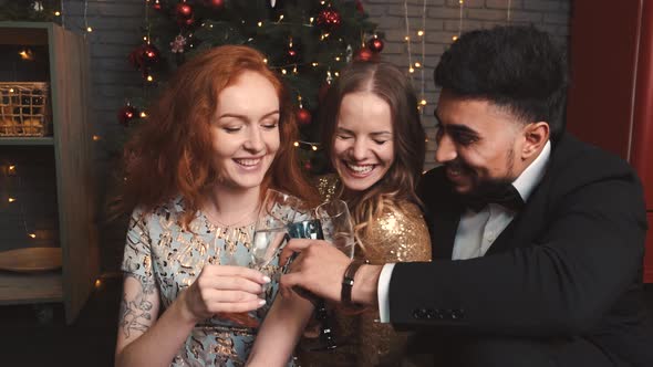 Happy Friends Drinking Champagne During New Year's Eve Celebration