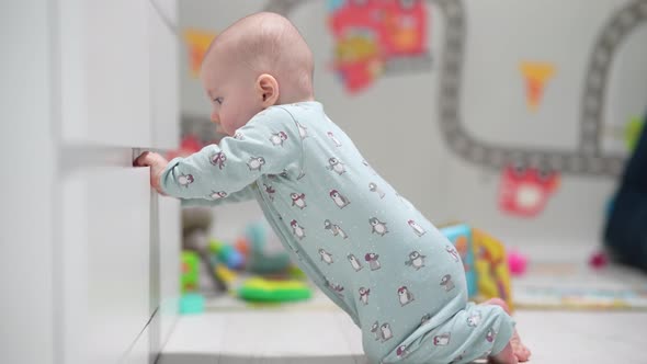 A Crawling Funny Baby Indoors at Home Play with Toys