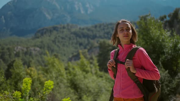 Slow Motion Camera Moving Around Beautiful Young Woman Hiker Standing on Beautiful Mountain