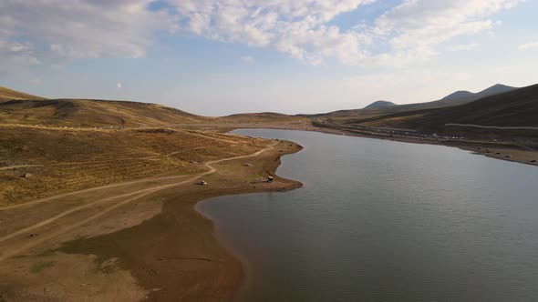 Aerial View From Behind ATVs by Lake and Mountain