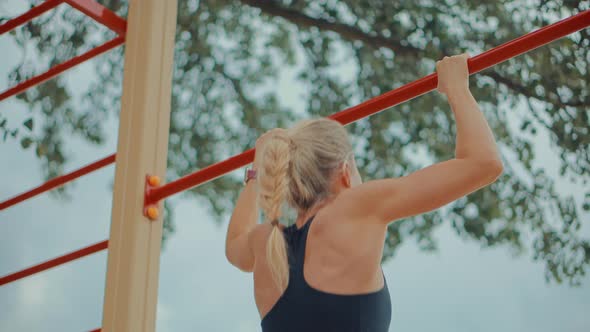 Woman On Pull-up Bars Exercising. Chin Ups Burn Fat. Fit Chest Exercise. Athlete Pullups Workout.