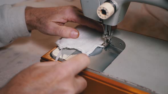 Tailor at Sewing Machine Sews a Homemade Medical Face Mask To Protect Covid-19