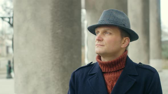 Portrait of an attractive young artist looking up. Handsome man in hat. Lifestyle concept