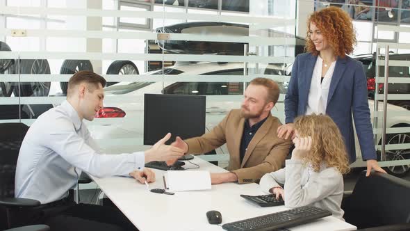 Caucasian Family Get Keys From Their New Car