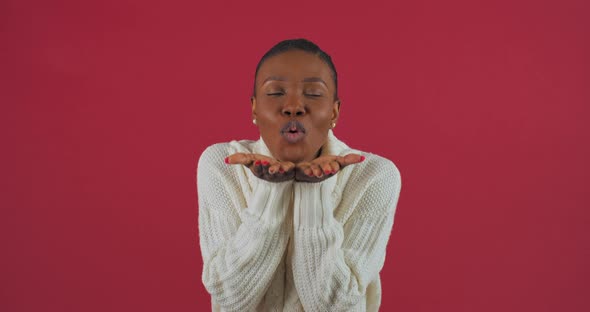 Afro American Woman Mixed Race Girl Stands Posing on Red Background in Studio Wears White Sweater