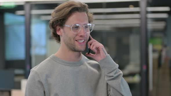 Portrait of Young Businessman Talking on Smartphone