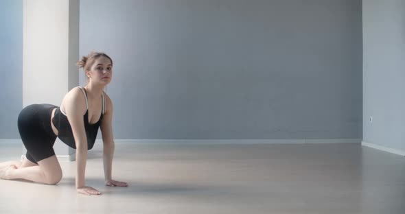 Attractive Young Woman Stands on Her Arms and Leaning Forward, Gymnast Performs Various Yoga