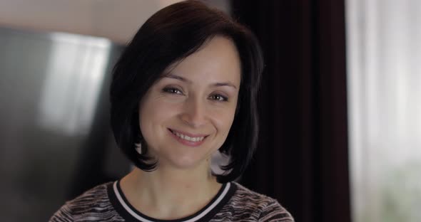 Portrait of Pretty Caucasian Young Brunette Woman Smiling at Home