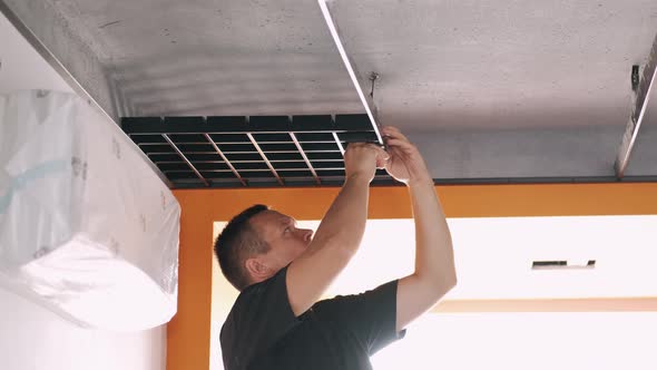 Male Workers Installing Panels for Open Cell Ceiling