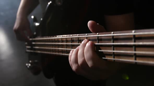 Closeup. Chord on Guitar. Man Strums and Plays Electric Guitar