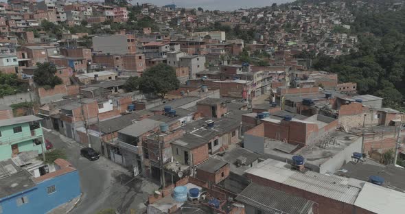 Aerial shot getting close to small houses in a poor community