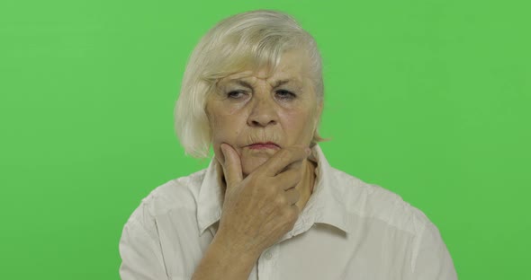 An Elderly Woman Thinks About Something. Old Thoughtful Grandmother. Chroma Key