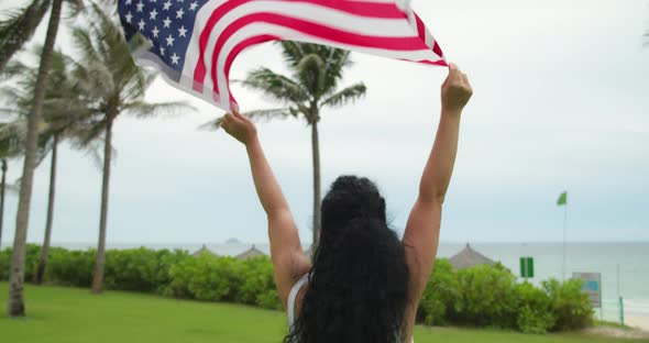 The Concept of Patriotism Independence Day and Holidays a Happy Smiling Young Woman in a Tshirt Runs