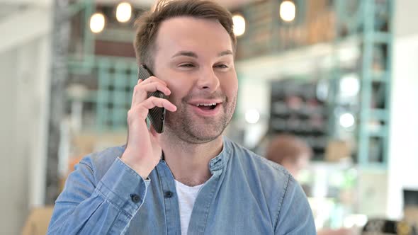 Portrait of Smiling Casual Man Talking on Smartphone