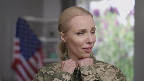 Closeup Portrait of Anxious Military Woman with PTSD Unzipping Camouflage Uniform Breathing Rapidly