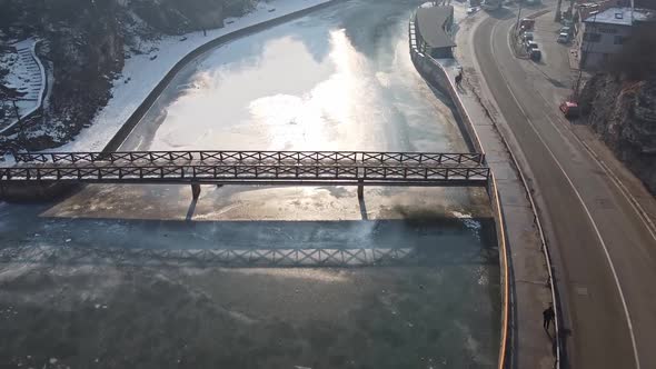 Bridge Over A Frozen River In Winter