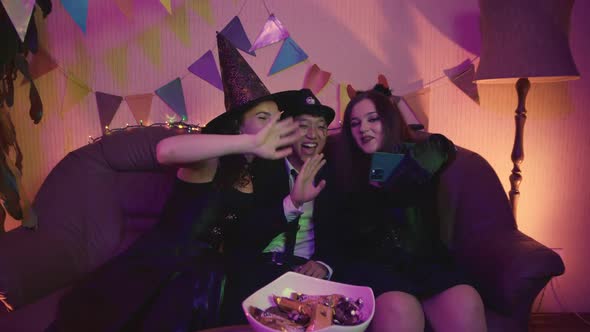 A Group of Friends in Creepy Costumes Communicate Via Video Link Via Phone and Laugh on Halloween