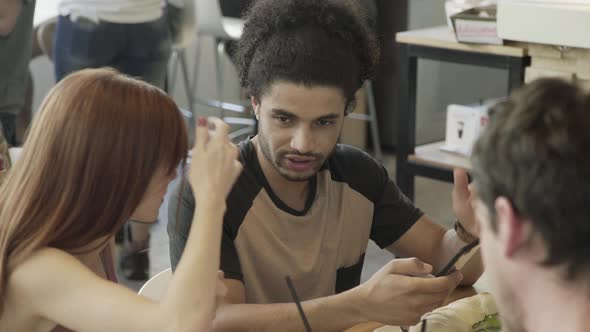 Woman explaining smart phone to companion