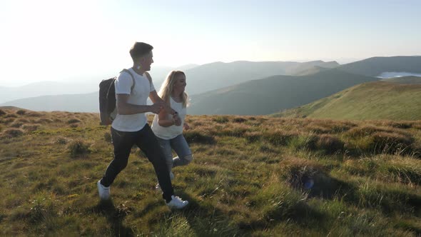 Couple running on a hill