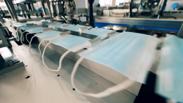 Medical Masks Moving Along a Conveyor Belt