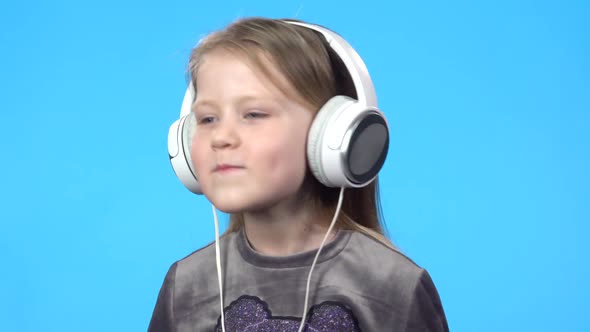 Little Girl Smiling, Listening To the Music, Nodding Her Head.