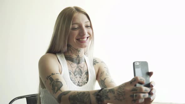 Young woman taking selfie with smart phone