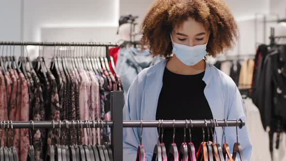 Woman Consumer with Curly African Hairstyle Stylish Shopper Girl in Clothing Store Wears Protective