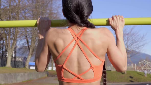 Behind View of Sporty Woman Doing Pullups, Closeup