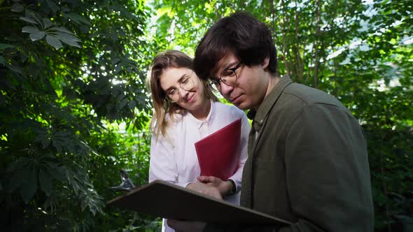 Young Agricultural Engineers Working in Greenhouse