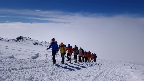 Group of Alpinists is Going on Mountain Slope Sportive Alpinism and Tourism in Mountains