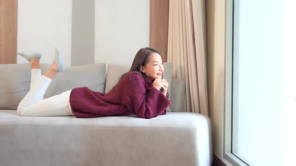 Asian woman sit on sofa and relax