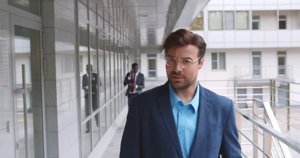 Handsome Businessman Walking Outside Business Center