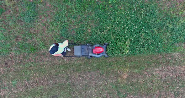Women in Lawn Mower Gardener Cutting the Grass Rideon Lawnmower an Aerial View