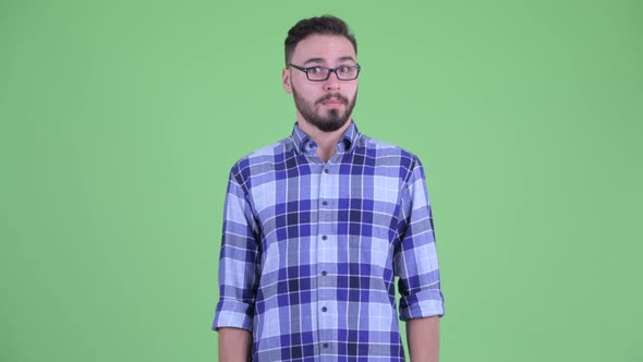 Funny Young Bearded Hipster Man Looking Shocked and Guilty